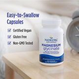 Nordic Naturals Magnesium Glycinate 250mg capsules on a wooden table