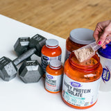 NOW Foods Creatine Monohydrate 272g on a gym bench