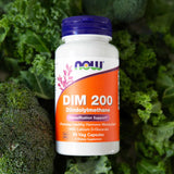 NOW Foods DIM 200 Capsules with a glass of water