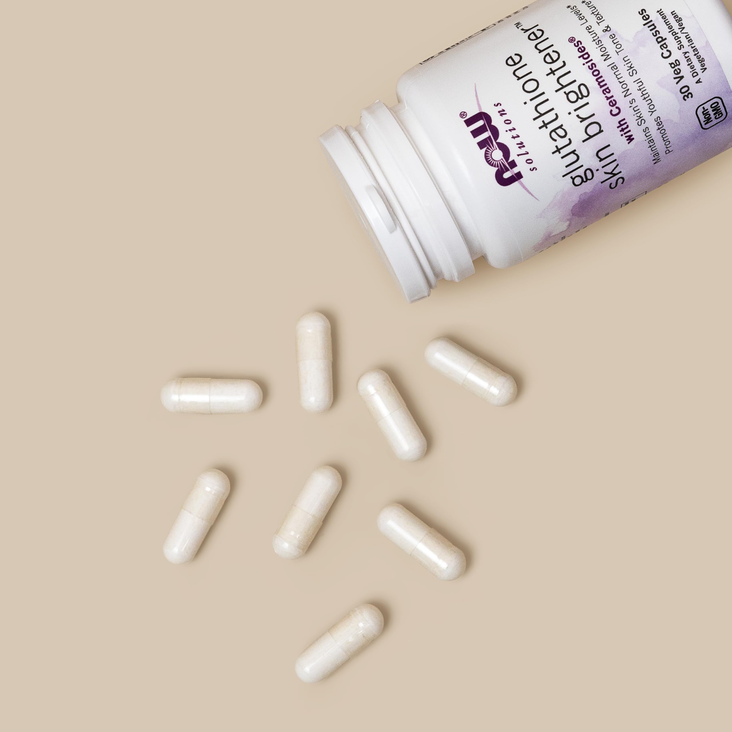 NOW Foods Glutathione Skin Brightener capsules in a hand