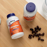 NOW Foods Ubiquinol CoQ10 120g softgel capsules on a wooden table