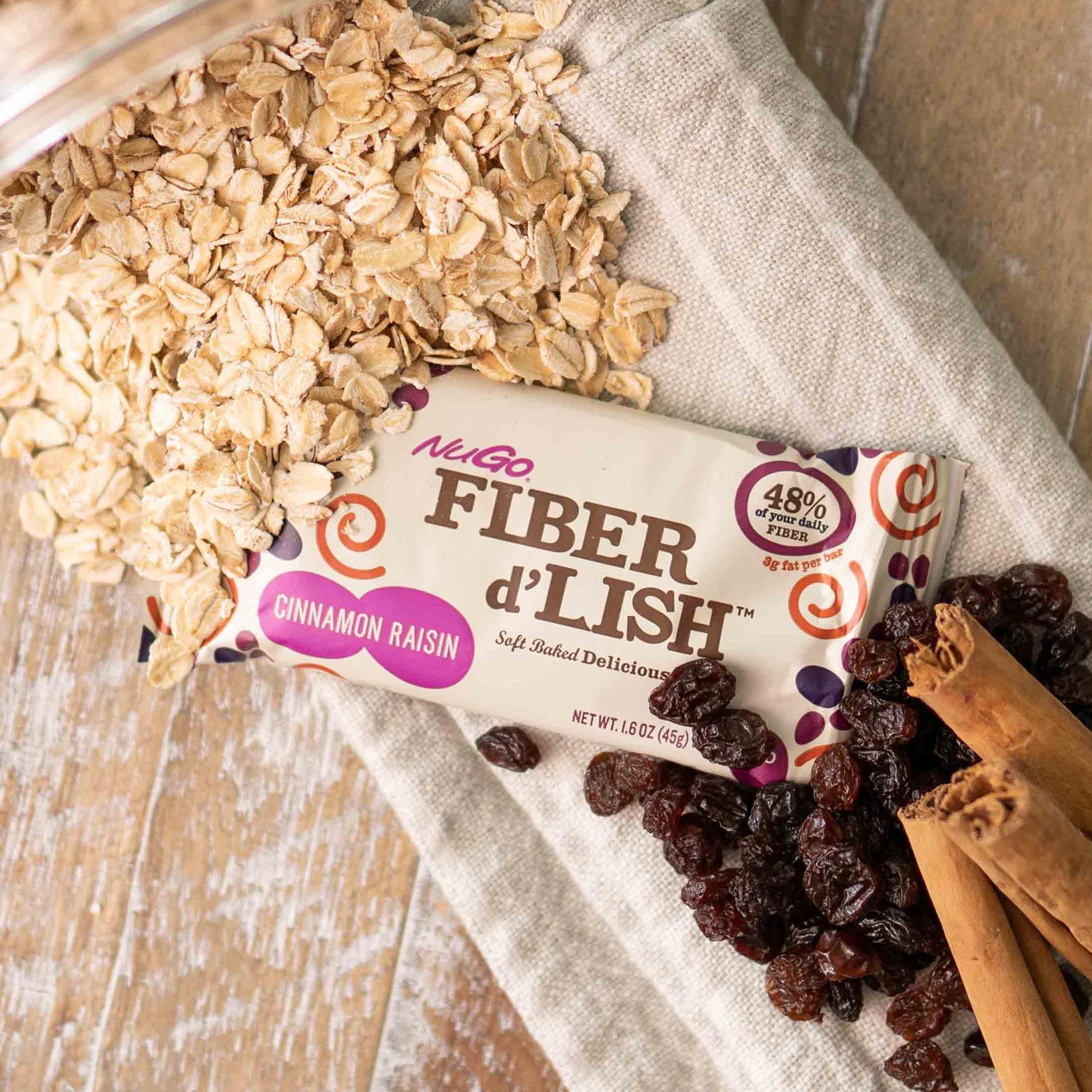NuGo Fiber d'Lish Soft-Baked Fiber Bar on a wooden table