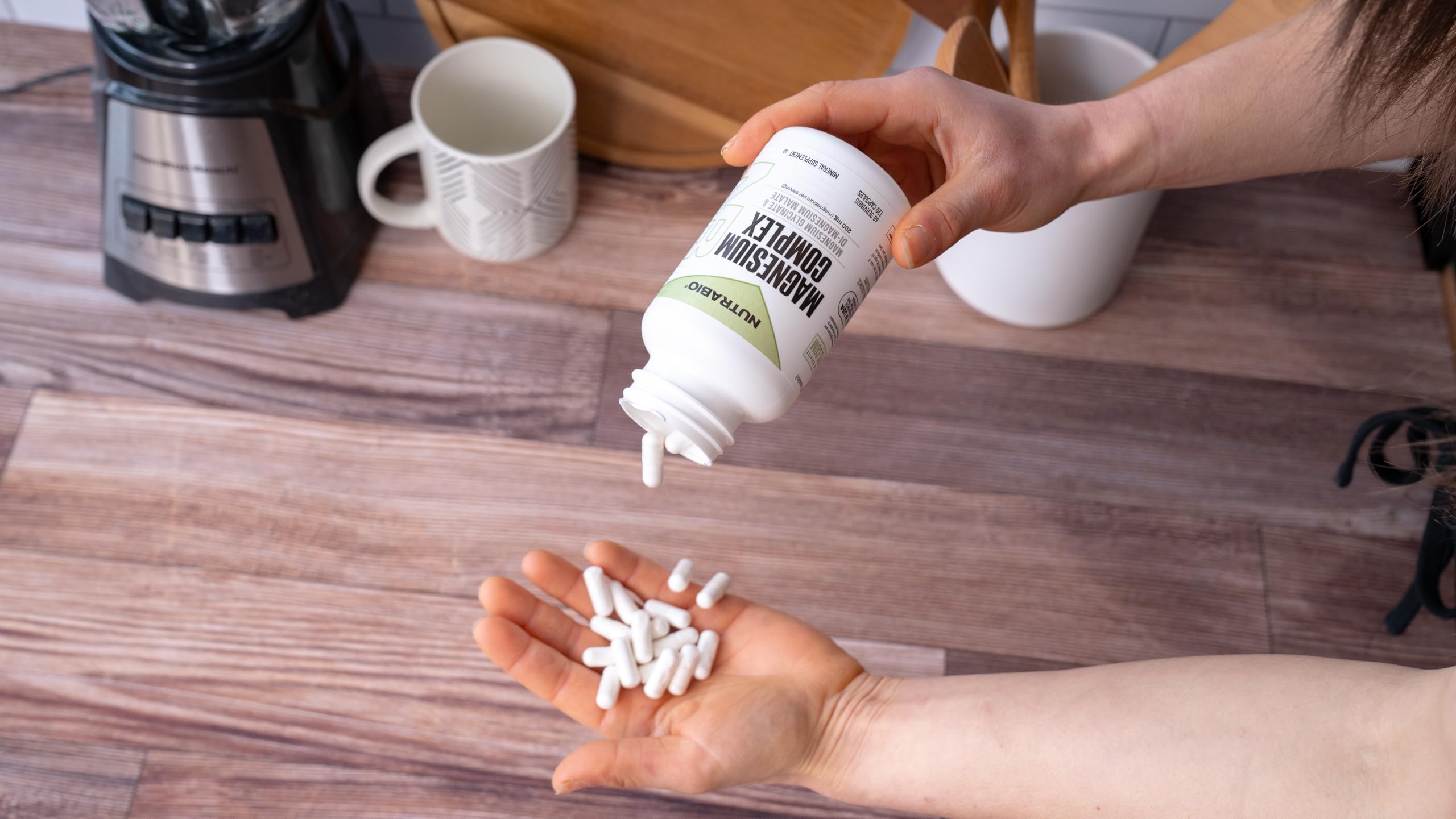 NutraBio Magnesium Capsules with a measuring spoon for dosage