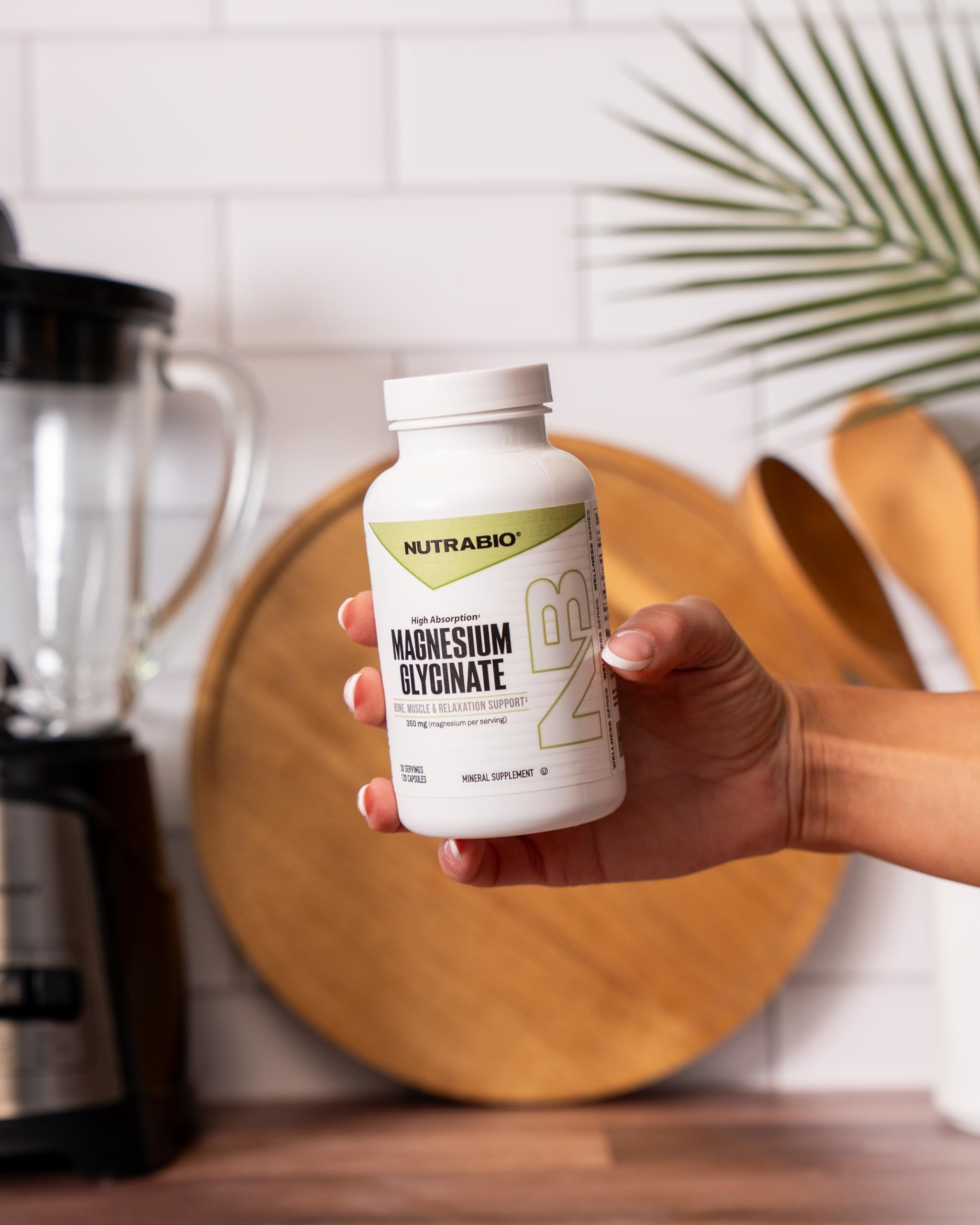 NutraBio Magnesium Glycinate 350mg capsules in hand