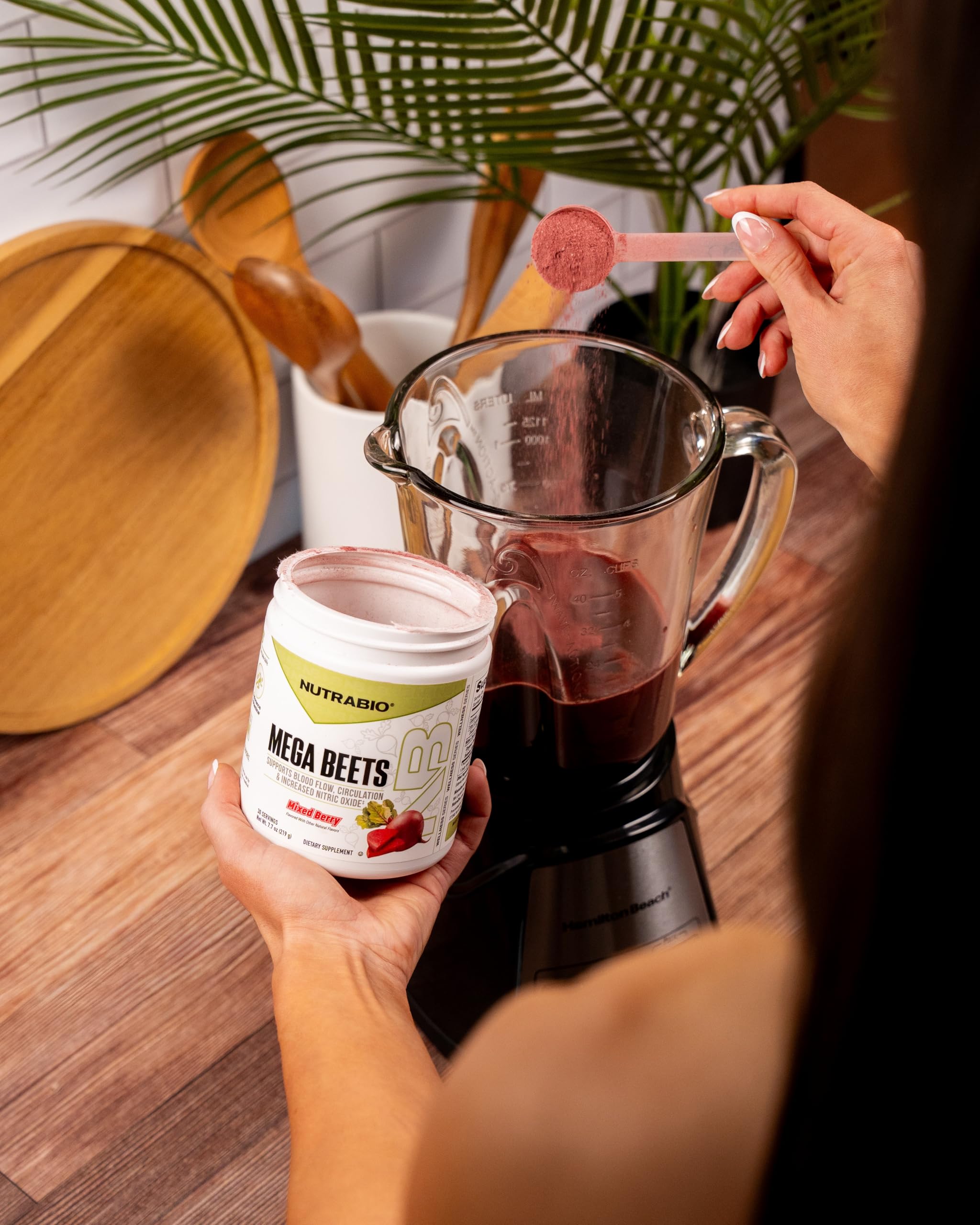 NutraBio Mega Beet Root Powder 280g in a glass of water