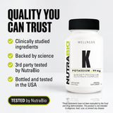 NutraBio Potassium Supplement 99mg 60 Capsules with a glass of water