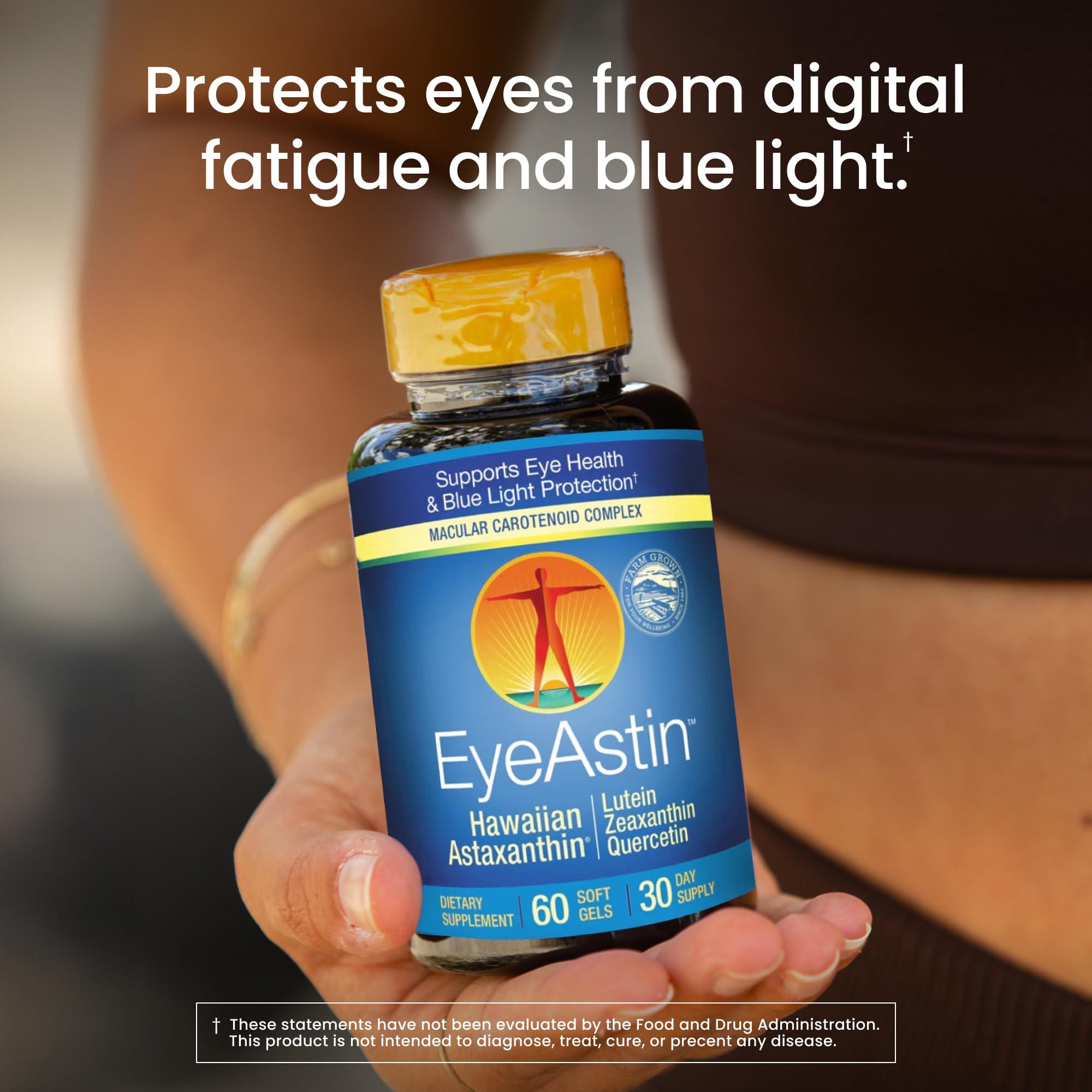 Nutrex Hawaii EyeAstin capsules in a hand