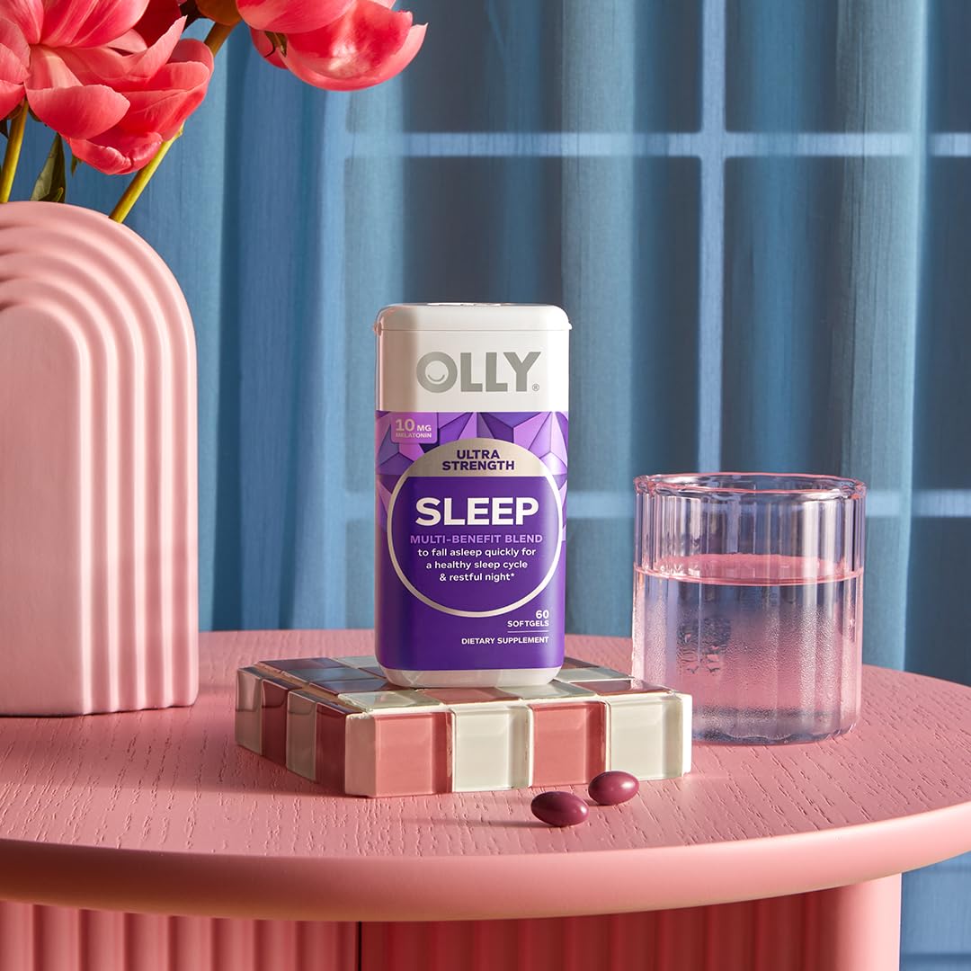 OLLIE Ultra Strength Sleep Softgels in a hand for size comparison