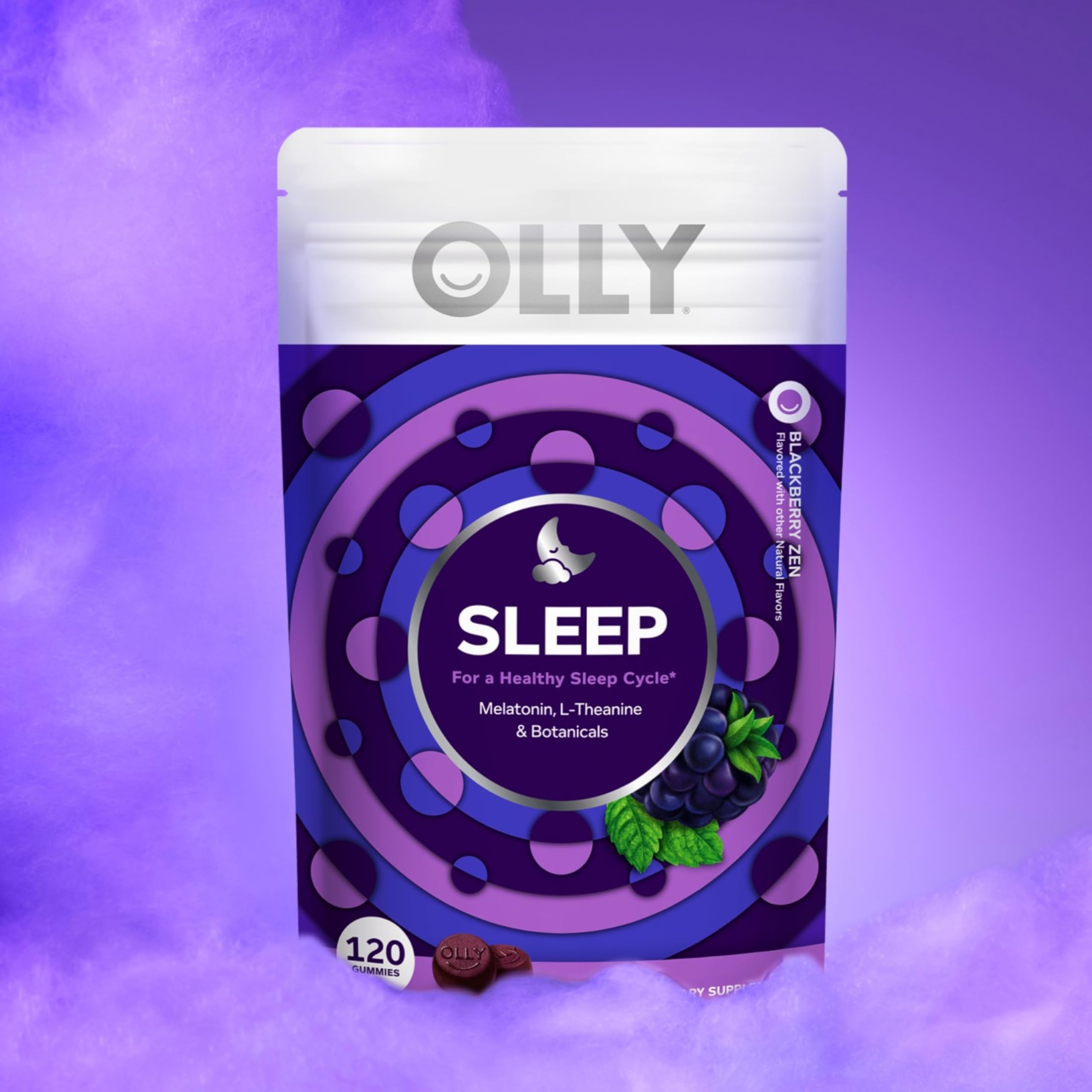 OLLY Sleep Gummies in a hand with a nightstand in background