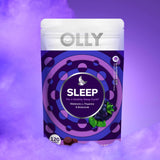 OLLY Sleep Gummies in a hand with a nightstand in background