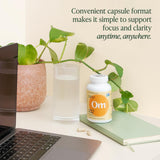 OM MUSHROOM SUPERFOOD Lion's Mane Mushroom Capsules on a wooden table