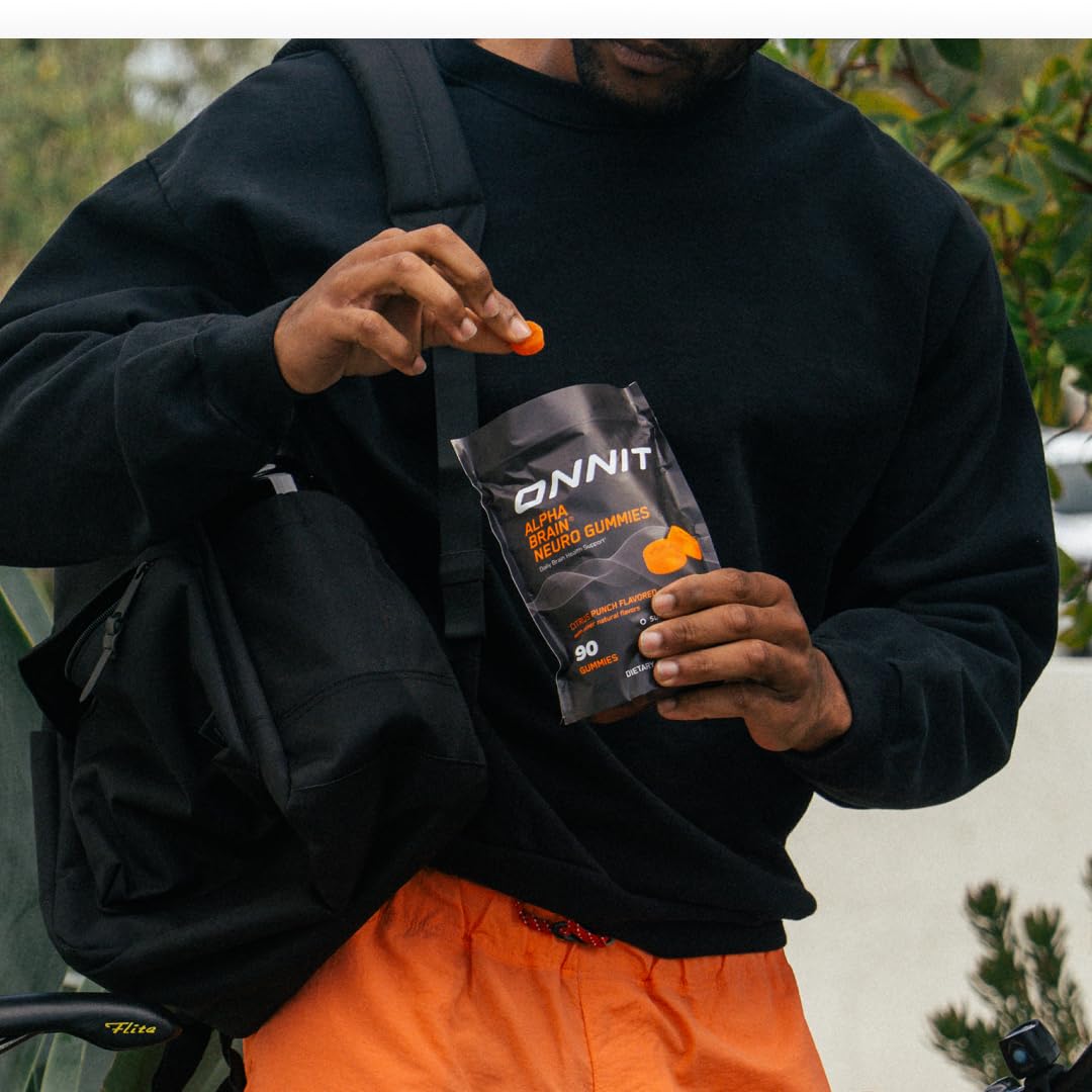 ONNIT Alpha Brain Neuro Gummies with a laptop and study materials