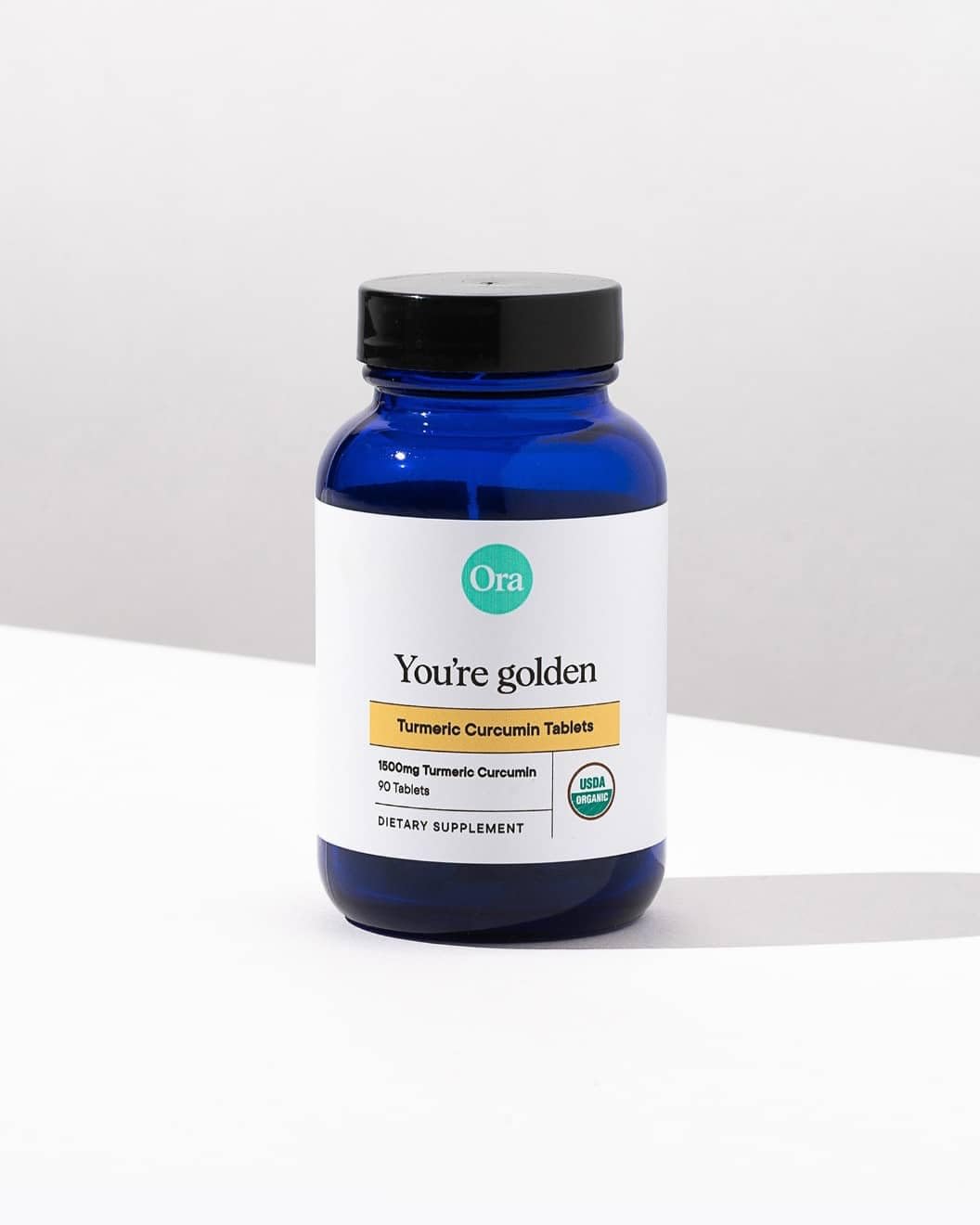 Ora Organic Turmeric Curcumin Supplement 1500mg on a wooden table