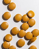 Ora Organic Turmeric Curcumin Supplement 1500mg with a glass of water