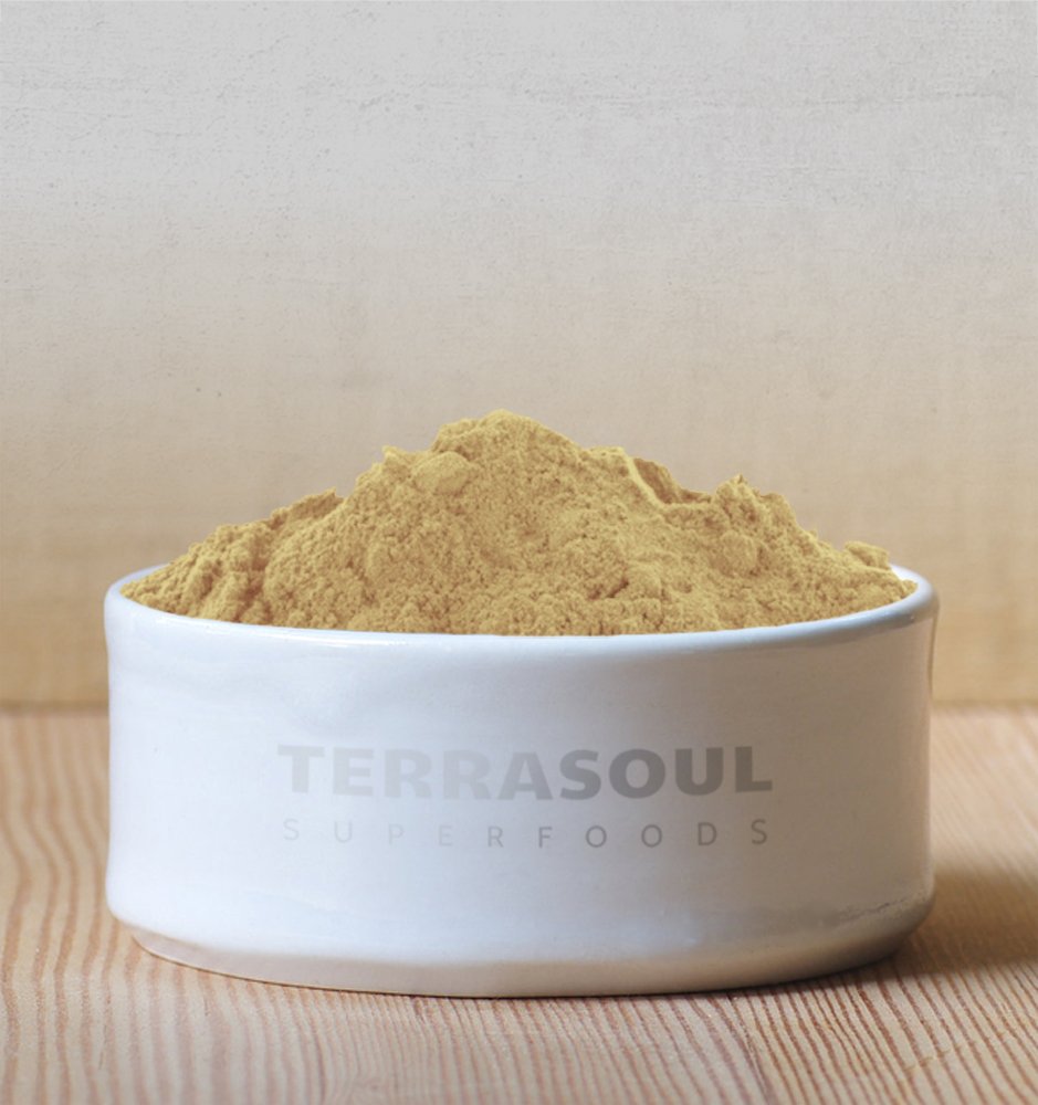 Organic Amla Powder in a bowl with a spoon