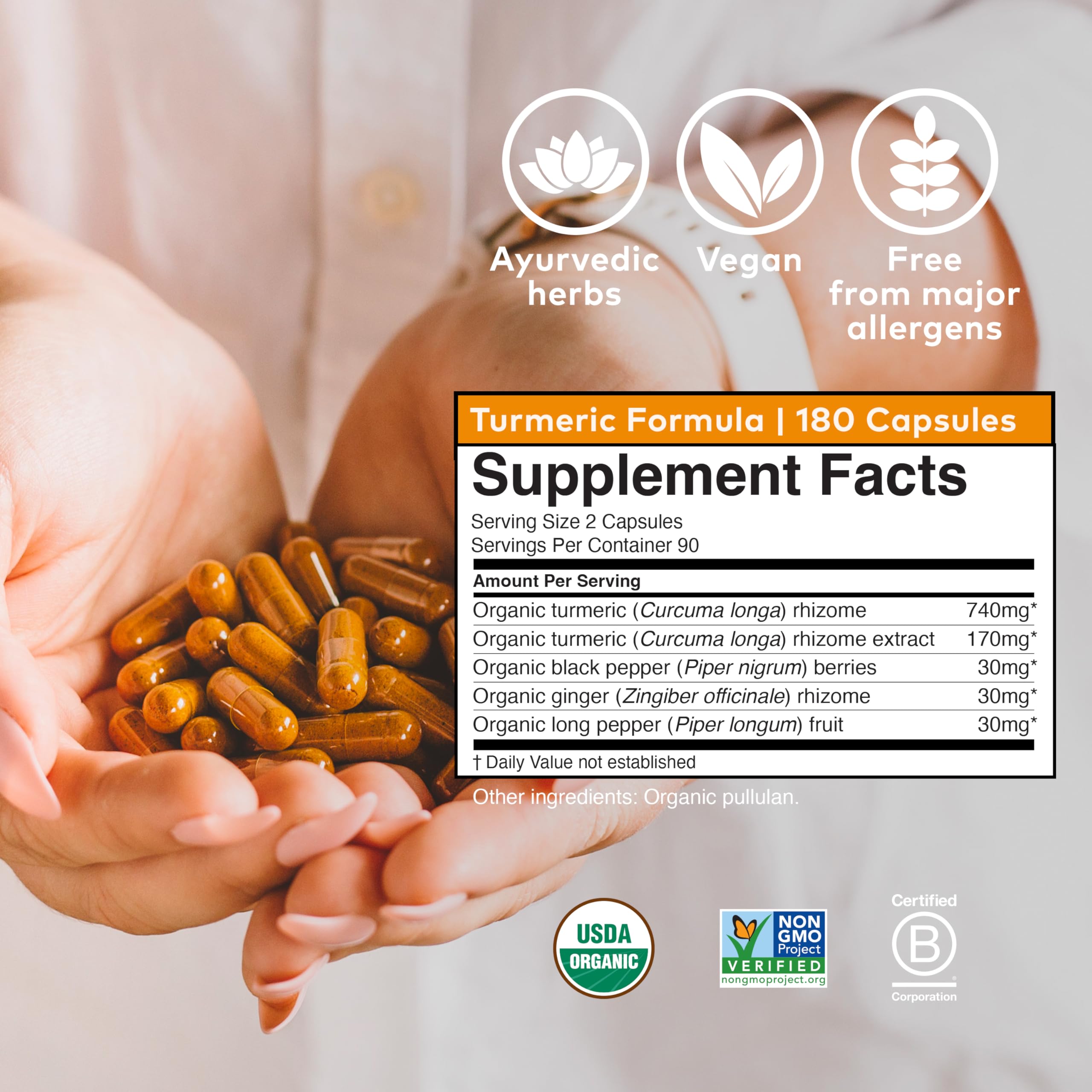 ORGANIC INDIA Turmeric Supplement in a hand for size reference