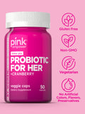 PINK Women's Probiotic Cranberry Supplement displayed with a glass of water