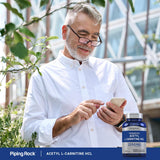 Piping Rock Acetyl-L-Carnitine 150g on a wooden table