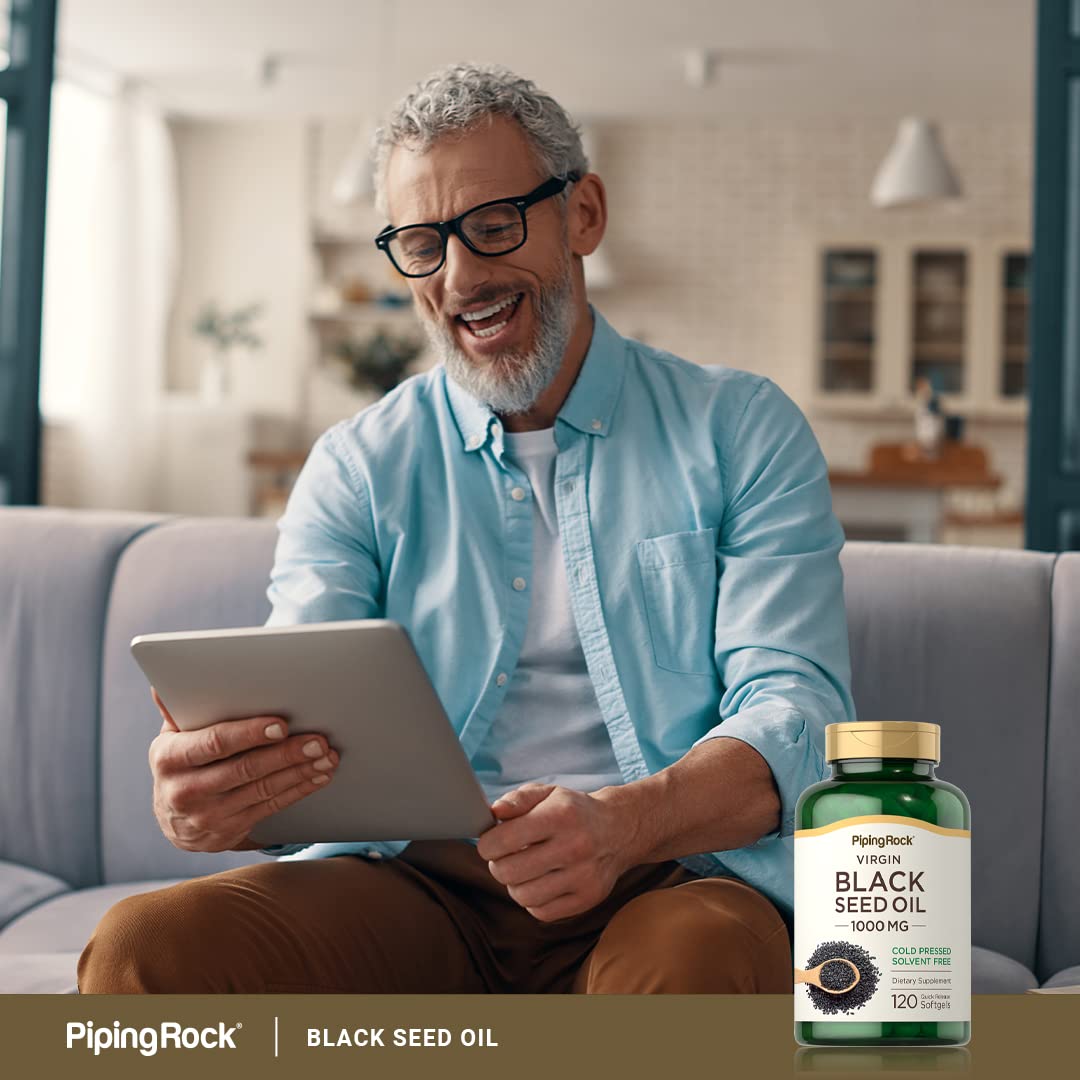 Piping Rock Black Seed Oil Cold Pressed Softgels on a wooden table