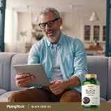 Piping Rock Black Seed Oil Cold Pressed Softgels on a wooden table