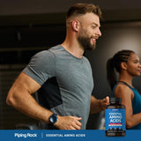 Piping Rock EAA & BCAA Supplement 3000mg capsules on a wooden table