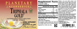 Planetary Herbals Triphala Gold capsules on a wooden surface