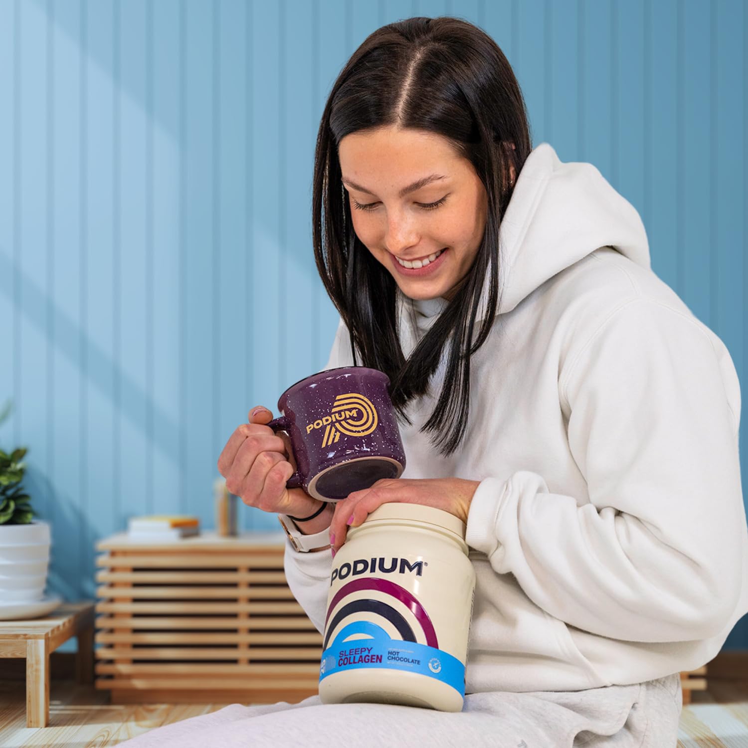 Podium Nutrition Sleepy Collagen 454g with a cup of hot chocolate