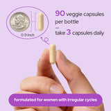 Premom Inositol Plus capsules with a glass of water