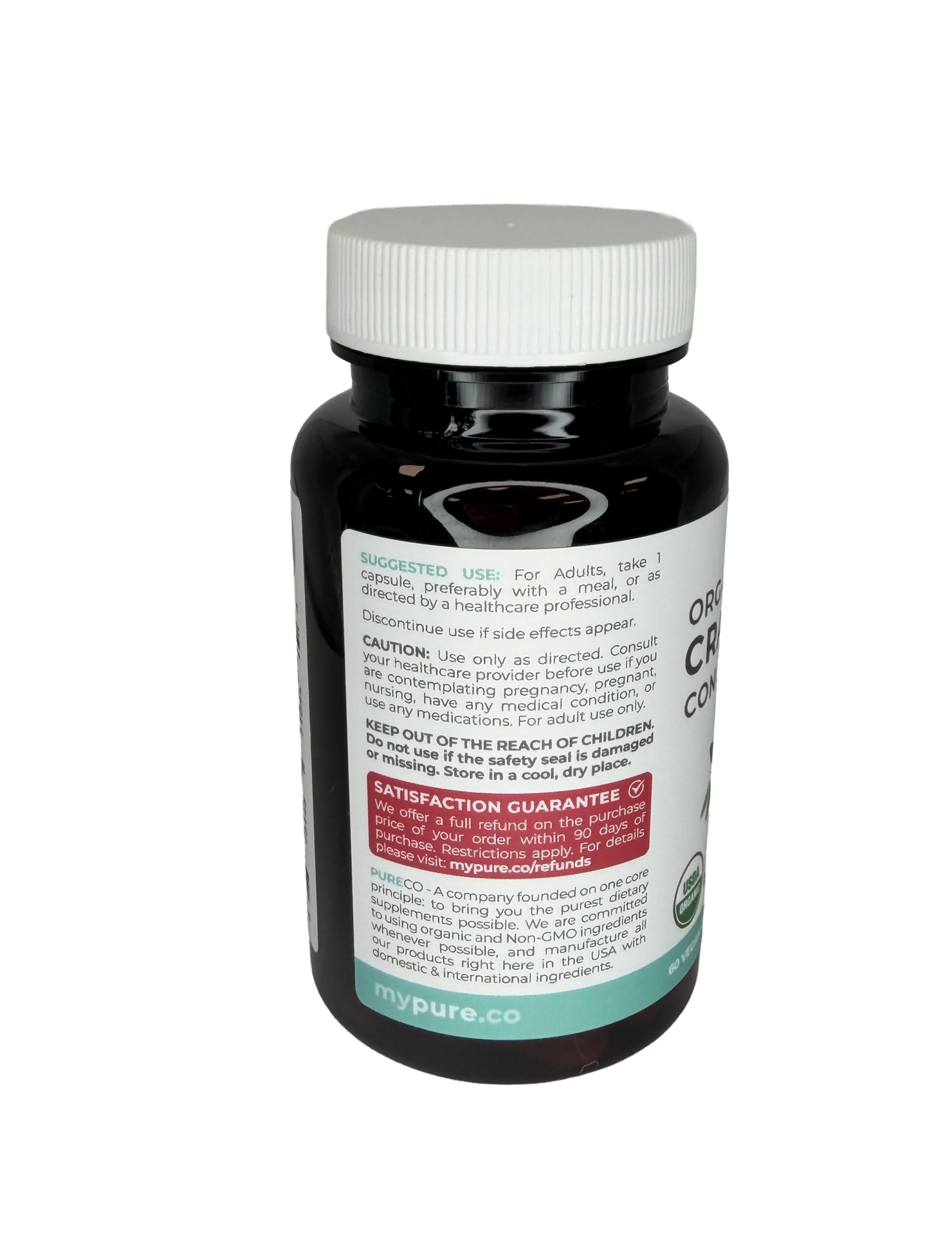 PURE CO Organic Cranberry Concentrate capsules with a glass of water