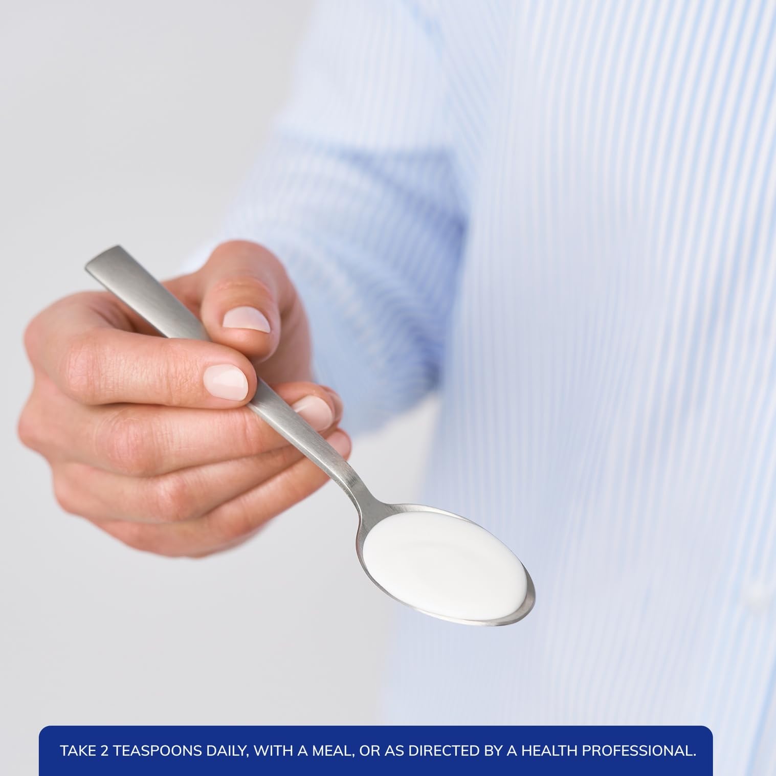 Pure Encapsulations Cal/Mag/D Liquid Calcium Supplement 630g pouring into a spoon