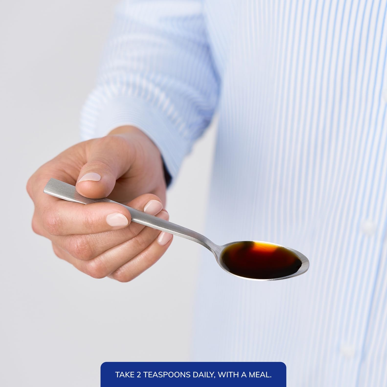 Pure Encapsulations Liquid Magnesium Glycinate 165mg pouring into a spoon