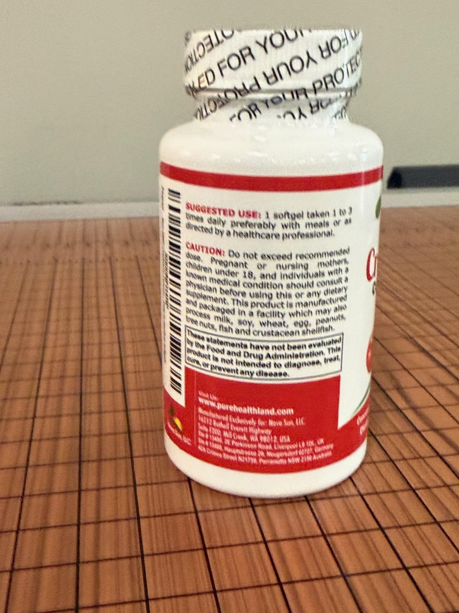 Pure Healthland Cranberry Concentrate Softgels with a measuring spoon