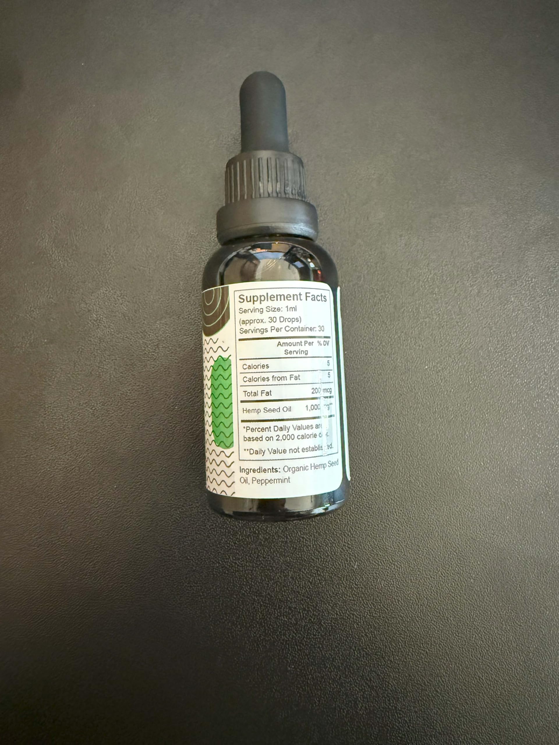 Pure Wellness Organic Hemp Seed Oil 30,000mg with a measuring spoon
