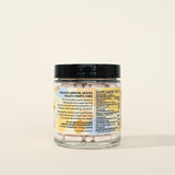 PYM Health Mood B Complete B12 supplement capsules with a glass of water