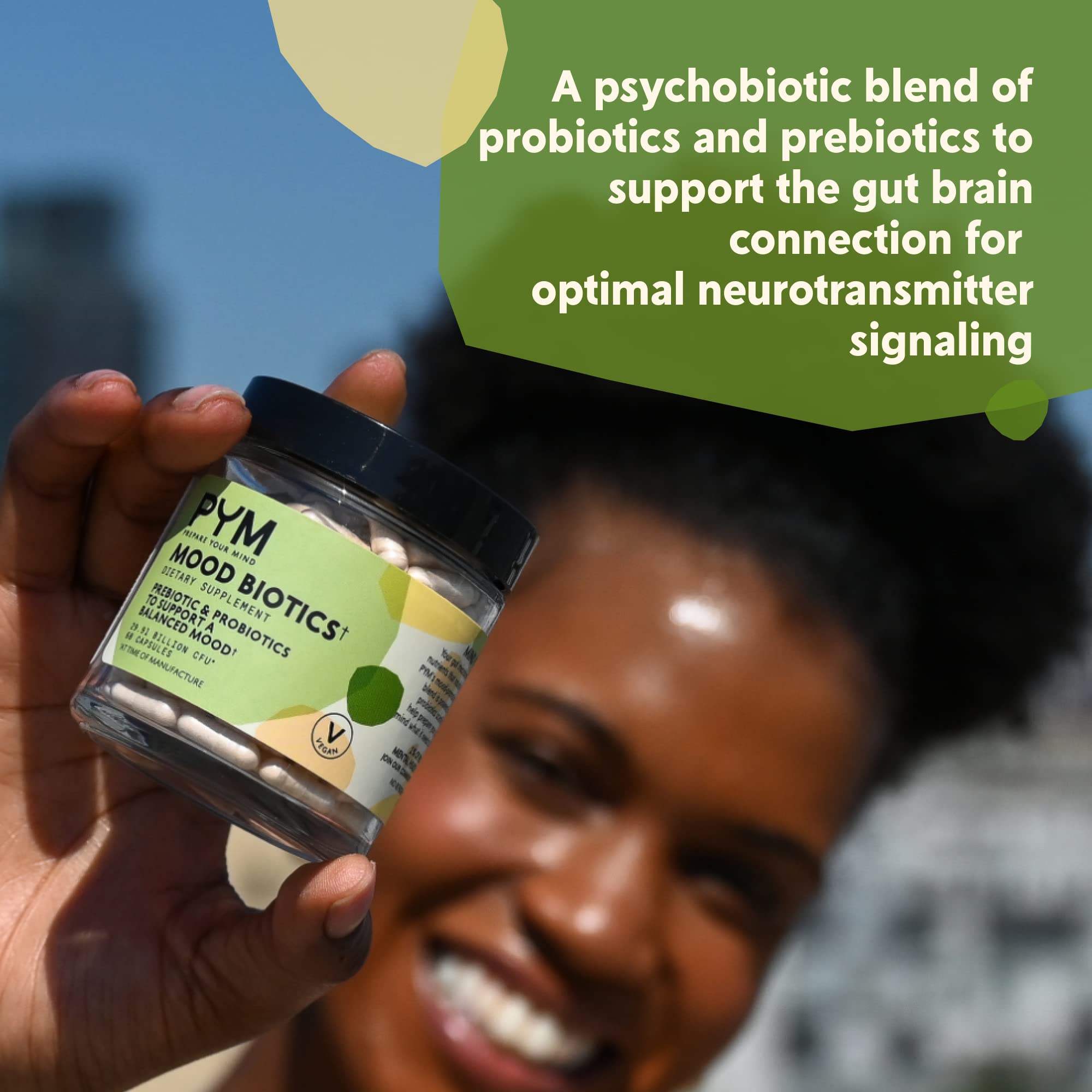 PYM Health Mood Biotics capsules with a glass of water