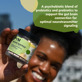 PYM Health Mood Biotics capsules with a glass of water