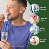 Red's Kitchen Sink Sea Moss Capsules lifestyle scene with a glass of water