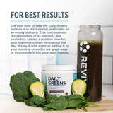 Revive Daily Greens Chocolate Supplement in a glass of water