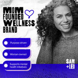 SAM+LEO daily wellness Gummies on a table with a glass of water
