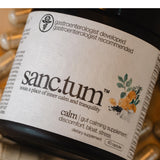 Sanctum daily Support Capsules with a glass of water