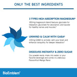Scoop of BioEmblem Triple Magnesium Powder next to a glass of water