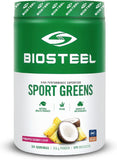 Scoop of BIOSTEEL Sport Greens powder in a glass of water