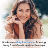Scoop of Garden of Life Collagen Creamer Powder on a wooden spoon