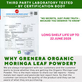 Scoop of Grenera Organic Moringa Powder on a wooden surface