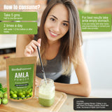 Scoop of Herbsforever Amla Powder on a wooden spoon