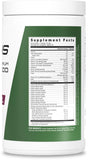 Scoop of JYM Greens Spirulina powder on a table