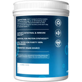 Scoop of MRM L-Glutamine Powder in a glass