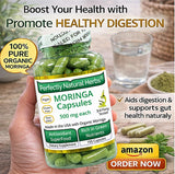 Scoop of Perfectly Natural Herbs Organic Moringa Powder on a wooden table