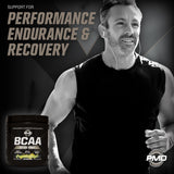 Scoop of PMD BCAA Powder 261g on a wooden table
