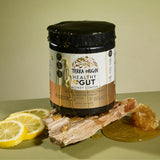 Scoop of TERRA ORIGIN Healthy Gut Powder on a wooden spoon